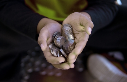 Cupped hands holding a pile of 10 cent coins Cupped hands holding a pile of 10 cent coins