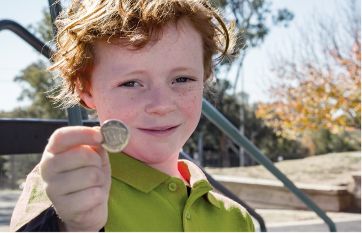 Child holding coin Child holding coin